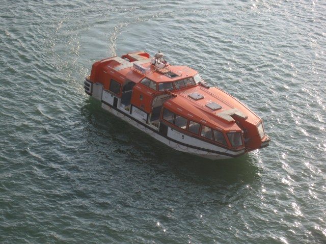 One of the ship's lifeboats as a tender