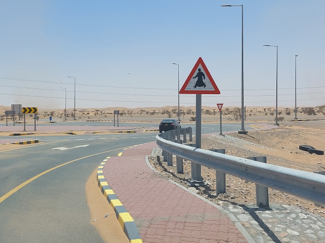Road sign pedestrian wearing a dishdasha