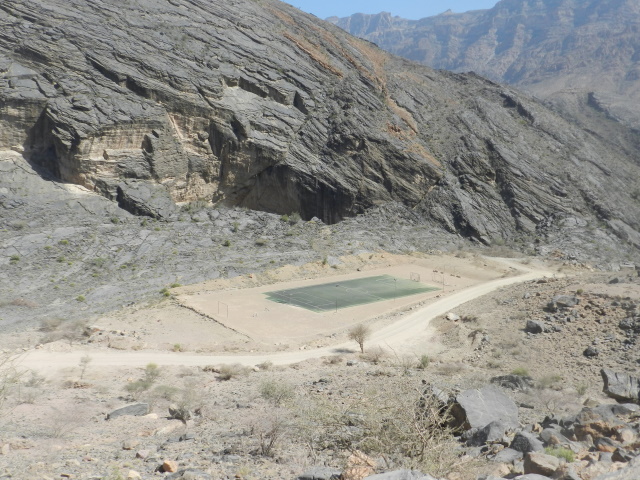 Green football pitch in the mountains